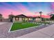 Charming single-Gathering home featuring a well manicured lawn and a decorative fence at 8117 E Lewis Ave, Scottsdale, AZ 85257