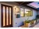 Modern front door with glass panels, contemporary lighting, a sleek mailbox, and drought tolerant landscaping at 8117 E Lewis Ave, Scottsdale, AZ 85257
