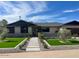 Inviting single-story home featuring a well-maintained front yard, walkway, and mature trees at 8117 E Lewis Ave, Scottsdale, AZ 85257