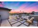 Inviting front patio with comfortable seating, a modern fire pit, stylish pavers and decorative concrete fence at 8117 E Lewis Ave, Scottsdale, AZ 85257