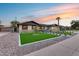 Charming exterior shot featuring a well-manicured front yard with fresh turf and modern hardscape at 8117 E Lewis Ave, Scottsdale, AZ 85257
