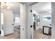 Hallway view with open doorways leading to a bedroom and office space at 8117 E Lewis Ave, Scottsdale, AZ 85257