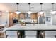 Modern kitchen with a large island, stylish pendant lighting, and stainless steel appliances at 8117 E Lewis Ave, Scottsdale, AZ 85257