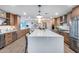 Bright, open kitchen featuring a large center island, stainless steel appliances, and modern wood cabinetry at 8117 E Lewis Ave, Scottsdale, AZ 85257