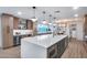 Bright kitchen with a large center island, modern pendant lights, and stainless steel appliances at 8117 E Lewis Ave, Scottsdale, AZ 85257