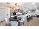 Inviting kitchen with a center island, modern lighting, stainless steel appliances, and adjacent dining area at 8117 E Lewis Ave, Scottsdale, AZ 85257