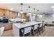 Spacious kitchen with a large island, bar seating, and open floor plan leading to the living room at 8117 E Lewis Ave, Scottsdale, AZ 85257