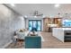 Open-concept living area with modern wallpaper, wood flooring, and seamless indoor-outdoor flow at 8117 E Lewis Ave, Scottsdale, AZ 85257