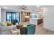 Spacious living room and kitchen combination featuring modern design, wood floors, and a clear view to the backyard pool at 8117 E Lewis Ave, Scottsdale, AZ 85257