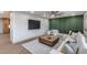 Stylish living room featuring a modern TV, comfortable seating, wood floors, and contemporary decor at 8117 E Lewis Ave, Scottsdale, AZ 85257