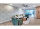 Open-concept living area with modern wallpaper, wood flooring, and access to the outdoor patio at 8117 E Lewis Ave, Scottsdale, AZ 85257