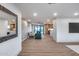 Spacious living area with wood floors, modern lighting, and seamless open floorplan to the kitchen at 8117 E Lewis Ave, Scottsdale, AZ 85257