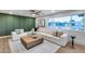 Bright living room with white seating, wood floors, contemporary ceiling fan, and a large window overlooking the outdoors at 8117 E Lewis Ave, Scottsdale, AZ 85257