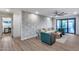 Open-concept living area with modern wallpaper, wood flooring, and access to the outdoor patio at 8117 E Lewis Ave, Scottsdale, AZ 85257