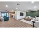 Open-concept living area with stylish decor, wood floors, modern lighting, and seamless flow to the kitchen at 8117 E Lewis Ave, Scottsdale, AZ 85257