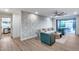 Open-concept living area with modern wallpaper, wood flooring, and access to the outdoor patio at 8117 E Lewis Ave, Scottsdale, AZ 85257
