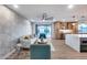 Large open-concept living space featuring a kitchen, dining, and living area with wood floors and modern design at 8117 E Lewis Ave, Scottsdale, AZ 85257