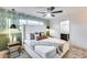 Stylish main bedroom features a modern fan, a large upholstered headboard and tasteful botanical wallpaper at 8117 E Lewis Ave, Scottsdale, AZ 85257