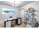 Bright home office features a modern desk, ample shelving, and a comfortable sitting area at 8117 E Lewis Ave, Scottsdale, AZ 85257