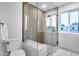Modern tiled shower with frameless glass door and built-in bench at 8117 E Lewis Ave, Scottsdale, AZ 85257