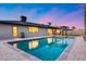 A captivating pool reflects the twilight sky, enhancing this home's outdoor allure at 8117 E Lewis Ave, Scottsdale, AZ 85257