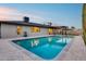 Backyard with pool, covered patio, and lush landscaping in a desert setting at 8117 E Lewis Ave, Scottsdale, AZ 85257
