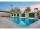 Inviting pool area features a lush lawn, privacy fence, and a covered patio at 8117 E Lewis Ave, Scottsdale, AZ 85257