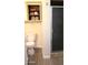 Clean bathroom with cabinet space above the toilet and a glass door shower at 930 W Mackenzie Dr, Phoenix, AZ 85013