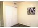 A bedroom featuring light colored walls, wood-look flooring, and a double closet at 930 W Mackenzie Dr, Phoenix, AZ 85013