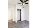 Neutral bedroom with light wood-look flooring and closet with sliding doors at 930 W Mackenzie Dr, Phoenix, AZ 85013