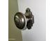 Classic metal doorknob on a painted wall; an antique finish with traditional style at 930 W Mackenzie Dr, Phoenix, AZ 85013