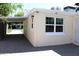View of the property's facade featuring neutral siding, windows, and carport at 930 W Mackenzie Dr, Phoenix, AZ 85013