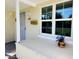Welcoming front porch with a decorative window and charming floral arrangement at 930 W Mackenzie Dr, Phoenix, AZ 85013