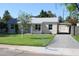 Charming single-story home with a well-manicured lawn and long driveway at 930 W Mackenzie Dr, Phoenix, AZ 85013