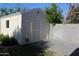 Detached garage with brick-paved patio, and exterior door at 930 W Mackenzie Dr, Phoenix, AZ 85013