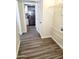 Hallway that connects the laundry room and kitchen, featuring wood-look vinyl flooring at 930 W Mackenzie Dr, Phoenix, AZ 85013