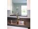 Stainless steel kitchen sink featuring gray counter, faucet and a window with natural light at 930 W Mackenzie Dr, Phoenix, AZ 85013
