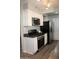 Contemporary kitchen equipped with stainless steel appliances, white cabinets, and sleek countertops at 930 W Mackenzie Dr, Phoenix, AZ 85013