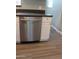 Modern kitchen showcasing a stainless steel dishwasher with white cabinets and gray counters at 930 W Mackenzie Dr, Phoenix, AZ 85013