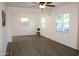 Open living room featuring hard surface floors, a ceiling fan, and large windows for natural light at 930 W Mackenzie Dr, Phoenix, AZ 85013