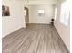 Bright and airy living room with large windows and modern gray wood-look flooring at 930 W Mackenzie Dr, Phoenix, AZ 85013