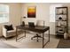 Well-lit home office featuring a modern desk setup, comfortable seating, and minimalist decor at 930 W Mackenzie Dr, Phoenix, AZ 85013