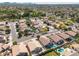 Expansive aerial view of a well-maintained neighborhood featuring beautiful homes, landscaping, and a community pool at 11840 N 59Th Ln, Glendale, AZ 85304