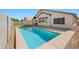 Inviting backyard features a sparkling pool, offering a serene oasis for relaxation and outdoor enjoyment at 11840 N 59Th Ln, Glendale, AZ 85304