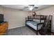 A cozy bedroom featuring a bunk bed, dresser, and neutral carpet, perfect for children or guests at 11840 N 59Th Ln, Glendale, AZ 85304