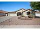 Charming single-story home featuring a well-manicured desert landscape and a cozy front porch seating area at 11840 N 59Th Ln, Glendale, AZ 85304