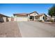 Single-story home featuring a two-car garage, desert landscaping, and a spacious driveway at 11840 N 59Th Ln, Glendale, AZ 85304