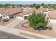 Aerial view of a well-kept single-Gathering home with desert landscaping and a long driveway in a residential neighborhood at 11840 N 59Th Ln, Glendale, AZ 85304
