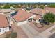 Aerial view of a charming home boasting a well-manicured lawn, solar panels, and desert landscaping at 11840 N 59Th Ln, Glendale, AZ 85304