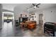 Open-concept living room with tiled floors, neutral paint, and comfortable seating at 11840 N 59Th Ln, Glendale, AZ 85304